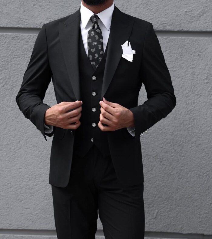 Groveland Court Slim fit black men’s three piece suit with peak lapels and with decorative silver buttons