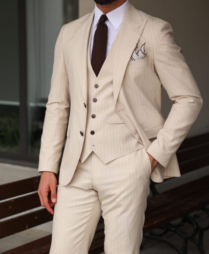 Batten Street <p>Slim fit all cream pinstriped men’s three piece suit with peak lapels</p>