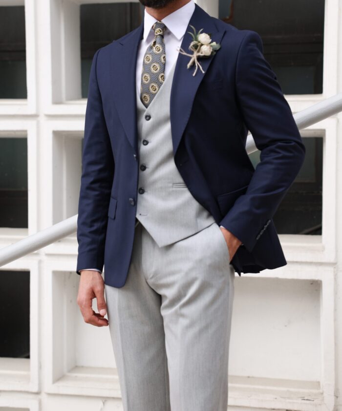 Penley Court <p>Slim fit grey and navy mixed three piece suit with peak lapels</p>
