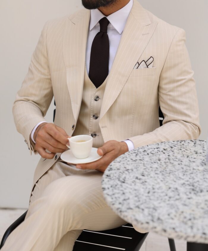 Vivian Grove Tailored slim fit cream pinstripe men's three piece suit with peak lapels