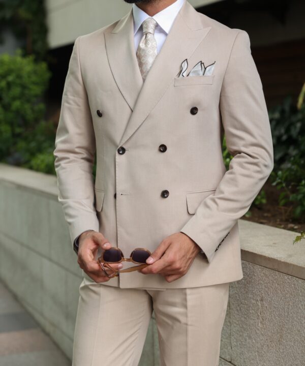 Blue blazer with checked waistcoat and long beige trousers  GYMP