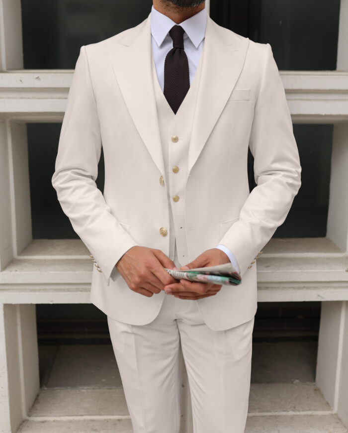 Caroline Court <p>Tailored slim fit cream three piece men’s suit with peak lapels</p>
