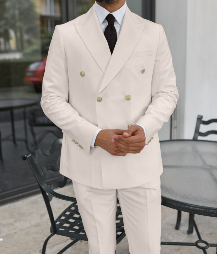 Seekers End Tailored slim fit cream double breasted men's suit with peak lapels with decorative gold buttons.