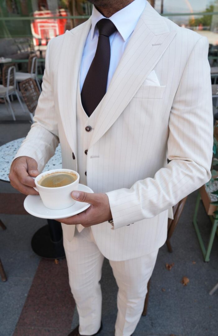 Peggotty Place Slim fit cream men’s three piece suit with peak lapels