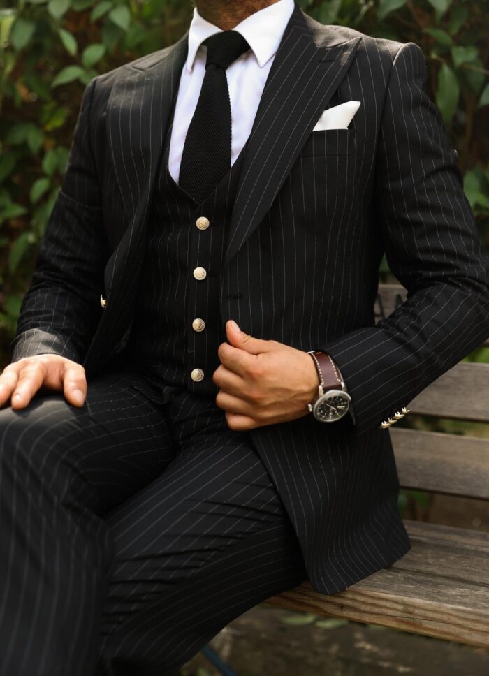Penfold Street Slim fit black men’s three piece suit with peak lapels and with decorative gold buttons