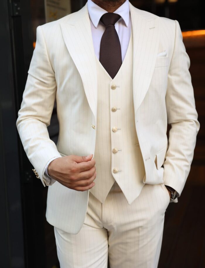 Pomeroy Street Slim fit cream men’s three piece suit with peak lapels and with decorative gold buttons