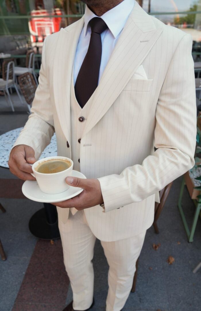 Peggotty Place Slim fit cream men’s three piece suit with peak lapels