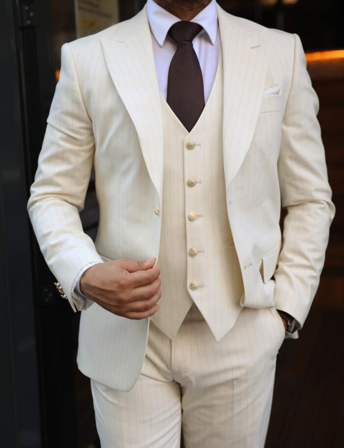 Pomeroy Street Slim fit cream men’s three piece suit with peak lapels and with decorative gold buttons