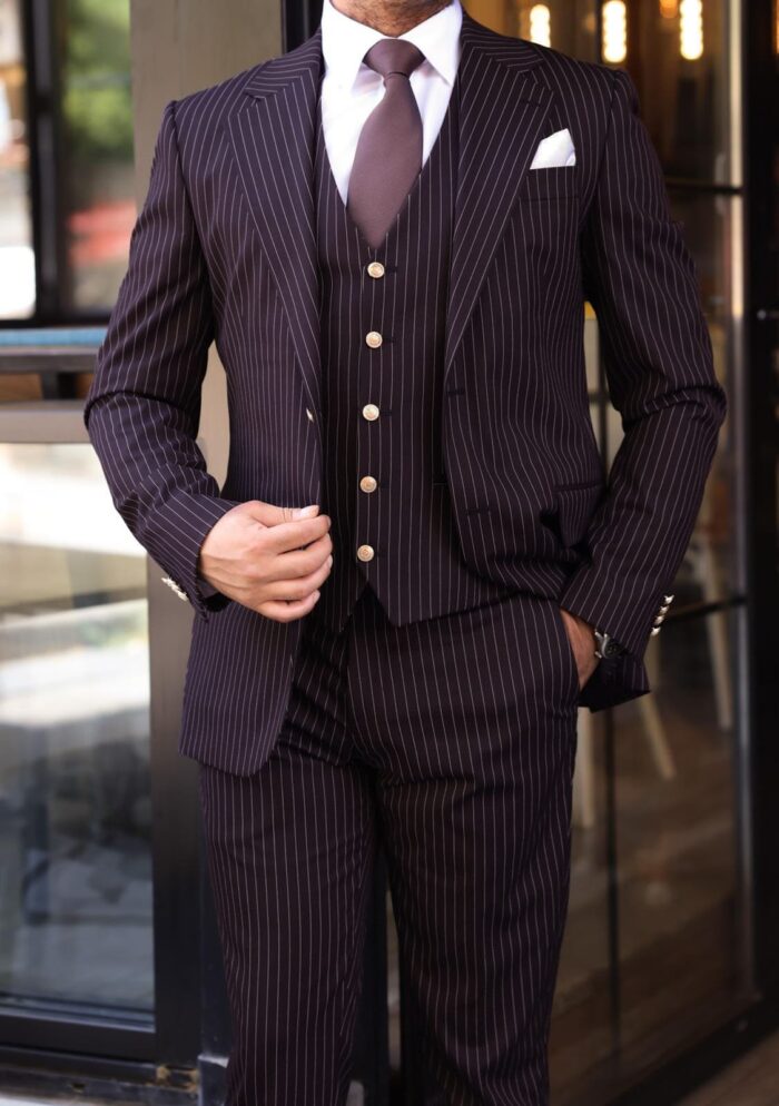 Mawbey Place Slim fit burgundy men’s three piece suit with peak lapels and with decorative gold buttons