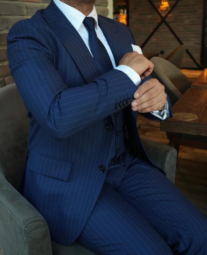 Cheney Road Slim fit navy pinstripe men’s three piece suit with peak lapels