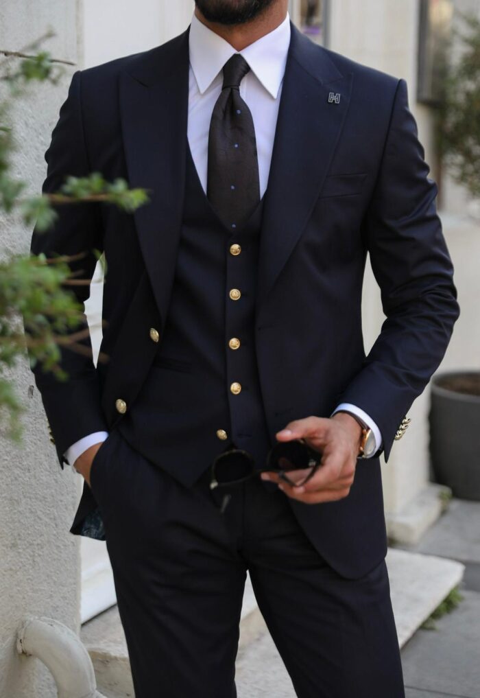 Kidd Cottages Slim fit dark blue men’s three piece suit with decorative gold buttons and peak lapels
